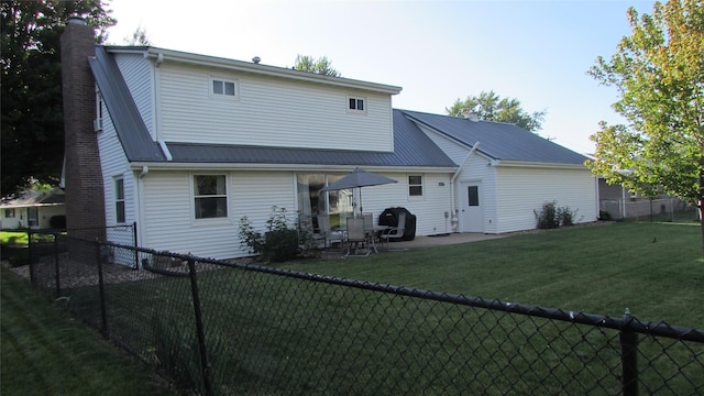 1401 N Grant St, Knoxville, IA 50138 - back of house featuring a chimney, a fenced backyard, and a patio area