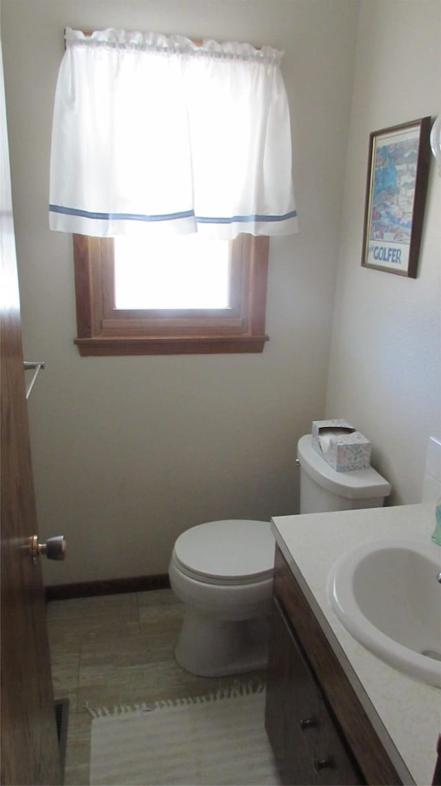 1401 N Grant St, Knoxville, IA 50138 - half bathroom featuring vanity and toilet