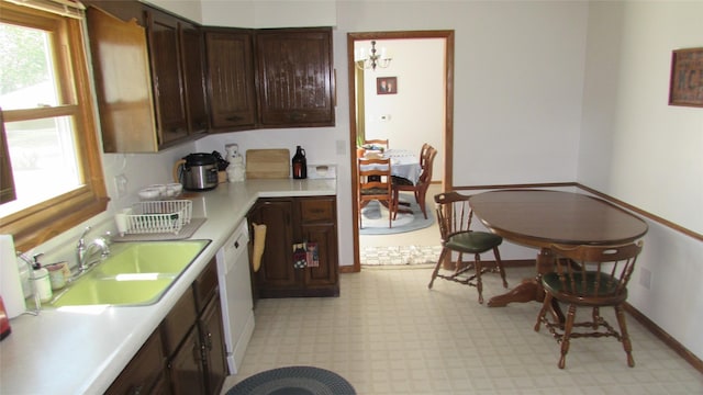 1401 N Grant St, Knoxville, IA 50138 - kitchen with light countertops, light floors, plenty of natural light, and dark brown cabinets