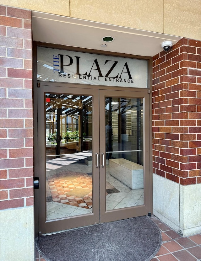 300 Walnut St Unit 1505, Des Moines, IA 50309 - property entrance with brick siding, a security system, and french doors