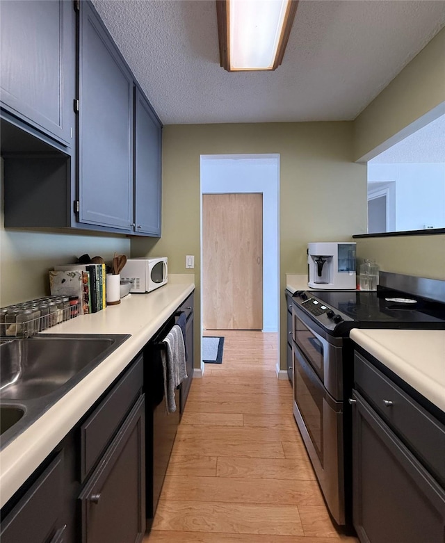 300 Walnut St Unit 1505, Des Moines, IA 50309 - kitchen with range with two ovens, dishwashing machine, light wood-style flooring, and light countertops