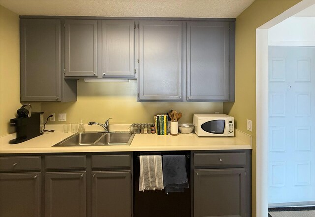 300 Walnut St Unit 1505, Des Moines, IA 50309 - kitchen featuring gray cabinets, white microwave, dishwasher, and light countertops