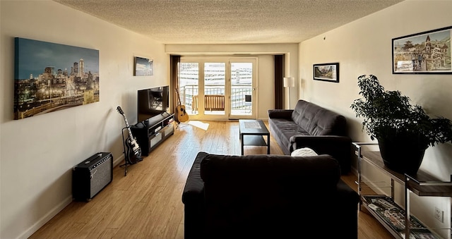 300 Walnut St Unit 1505, Des Moines, IA 50309 - living area featuring a textured ceiling and wood finished floors