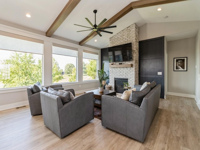 2013 Autumn Blaze Dr, Norwalk, IA 50211 - living room featuring plenty of natural light, ceiling fan, a fireplace, and light wood-style flooring
