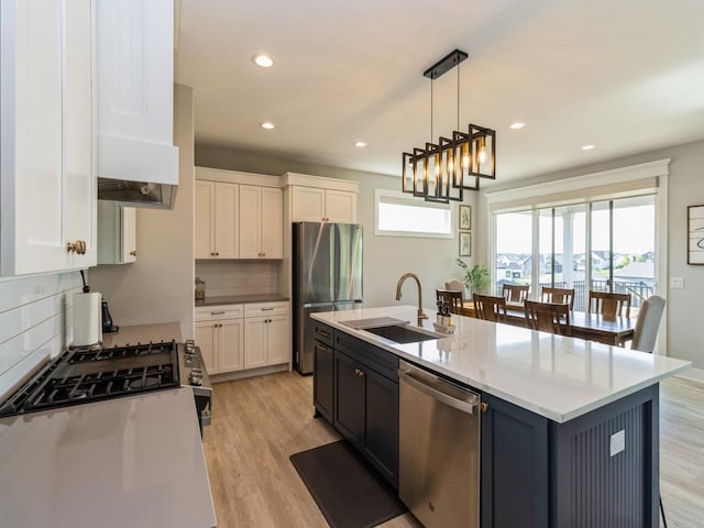 2013 Autumn Blaze Dr, Norwalk, IA 50211 - kitchen featuring appliances with stainless steel finishes, white cabinetry, backsplash, light wood-type flooring, and recessed lighting