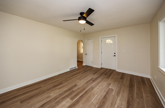 3912 53rd St, Des Moines, IA 50310 - unfurnished room featuring wood finished floors, a ceiling fan, and arched walkways