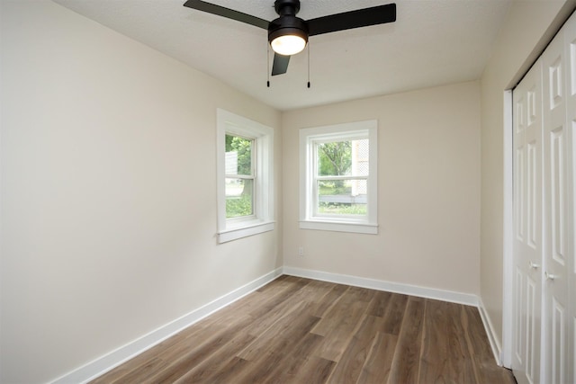 3912 53rd St, Des Moines, IA 50310 - unfurnished bedroom with a closet, wood finished floors, and a ceiling fan