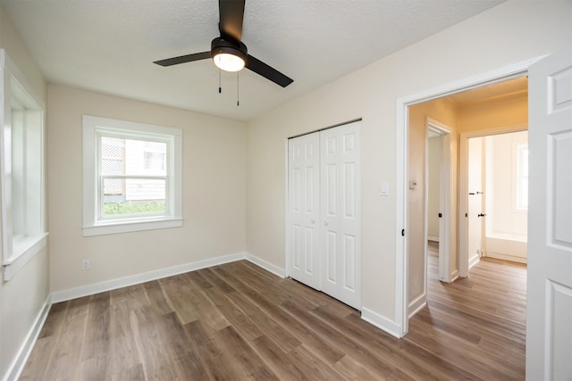 3912 53rd St, Des Moines, IA 50310 - unfurnished bedroom featuring wood finished floors, a closet, a ceiling fan, and a textured ceiling