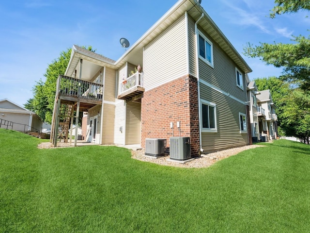 1106 N 6th St Unit 42, Indianola, IA 50125 - back of house with a yard, stairs, a deck, and brick siding