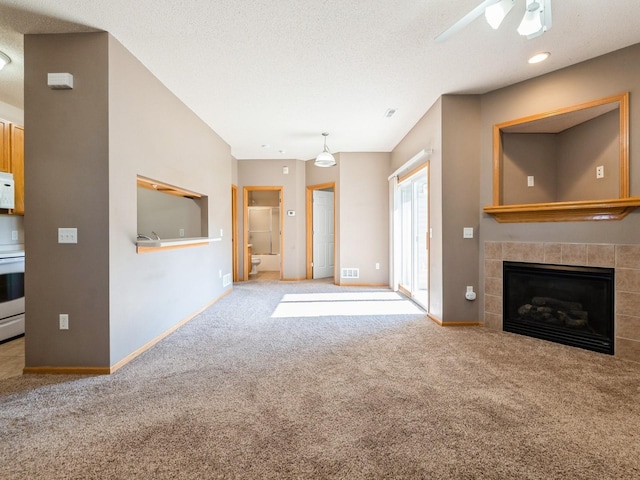 1106 N 6th St Unit 42, Indianola, IA 50125 - unfurnished living room featuring carpet, ceiling fan, a fireplace, and a textured ceiling