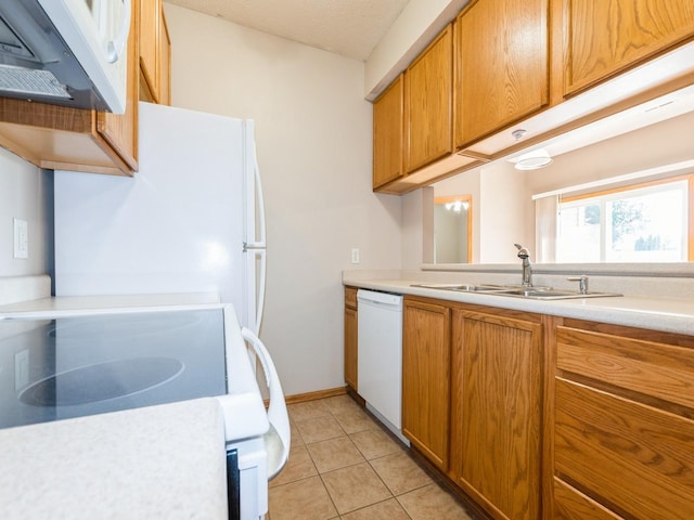 1106 N 6th St Unit 42, Indianola, IA 50125 - kitchen featuring white appliances, brown cabinets, light countertops, light tile patterned flooring, and ventilation hood