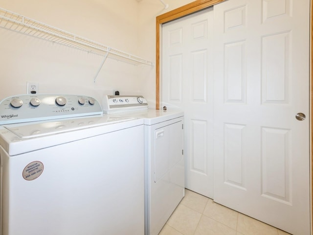 1106 N 6th St Unit 42, Indianola, IA 50125 - laundry area with washer and clothes dryer and light tile patterned floors
