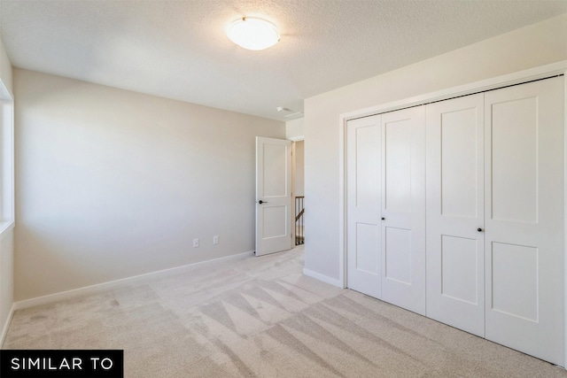 3601 NW 27th St, Ankeny, IA 50023 - unfurnished bedroom featuring light colored carpet, a closet, and a textured ceiling
