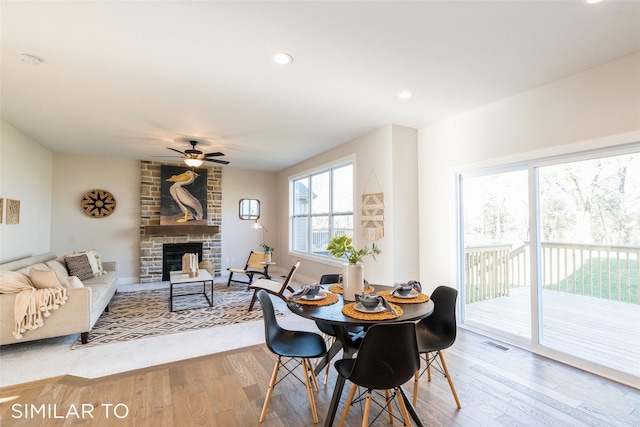 3601 NW 27th St, Ankeny, IA 50023 - dining area with a ceiling fan, wood finished floors, a fireplace, and recessed lighting