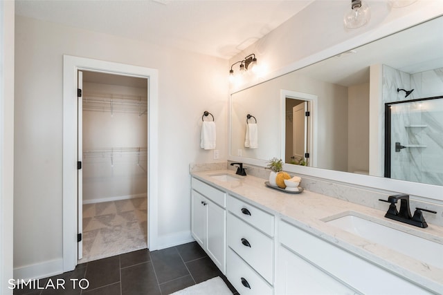 3601 NW 27th St, Ankeny, IA 50023 - full bathroom with double vanity, a shower stall, a walk in closet, and tile patterned floors