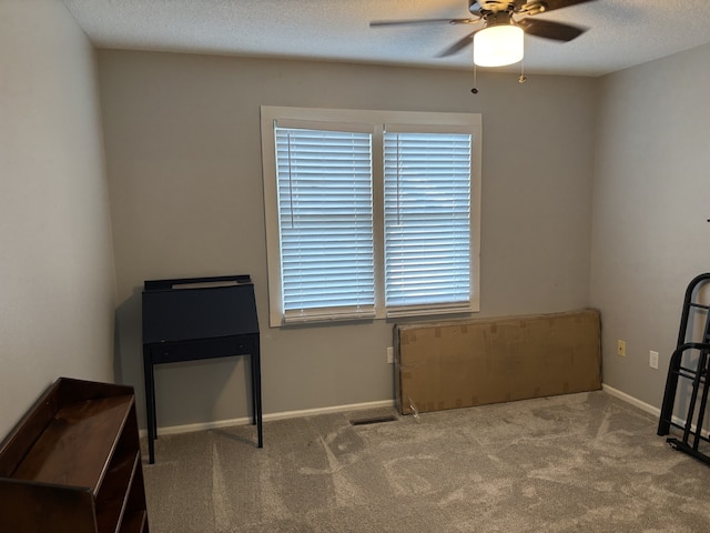 8200 Goodman Dr, Urbandale, IA 50322 - carpeted empty room featuring ceiling fan and a textured ceiling