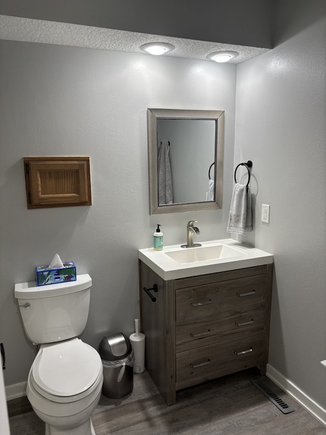 8200 Goodman Dr, Urbandale, IA 50322 - half bathroom with vanity and wood finished floors