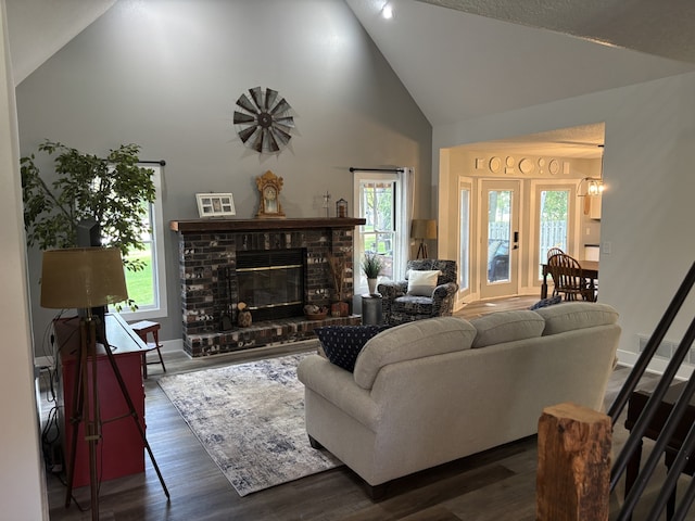 8200 Goodman Dr, Urbandale, IA 50322 - living area with high vaulted ceiling, plenty of natural light, wood finished floors, and a fireplace