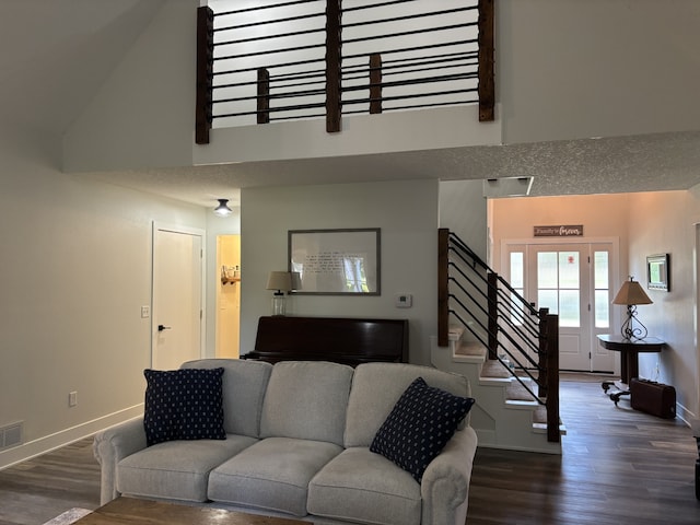 8200 Goodman Dr, Urbandale, IA 50322 - living area with dark wood finished floors, stairs, and high vaulted ceiling