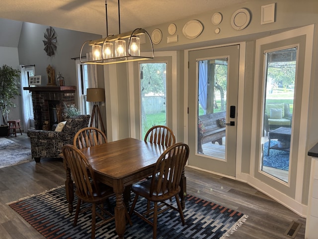 8200 Goodman Dr, Urbandale, IA 50322 - dining space with dark wood-style flooring and a brick fireplace