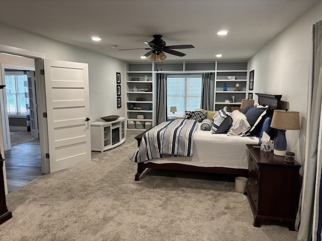 8200 Goodman Dr, Urbandale, IA 50322 - carpeted bedroom with multiple windows, recessed lighting, and ceiling fan