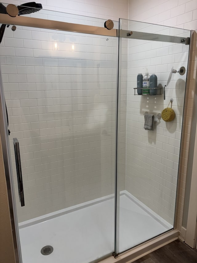 8200 Goodman Dr, Urbandale, IA 50322 - bathroom with a stall shower and wood finished floors