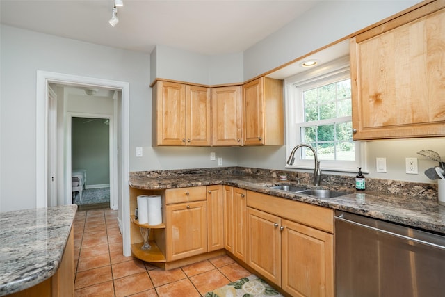 5625 Kingman Ave, Des Moines, IA 50311 - kitchen featuring dishwasher, dark stone counters, light tile patterned floors, and light brown cabinetry