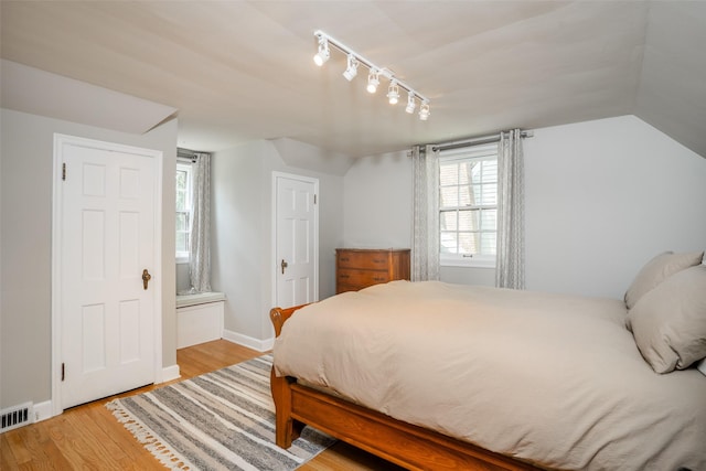 5625 Kingman Ave, Des Moines, IA 50311 - bedroom with track lighting, light wood-style floors, and multiple windows