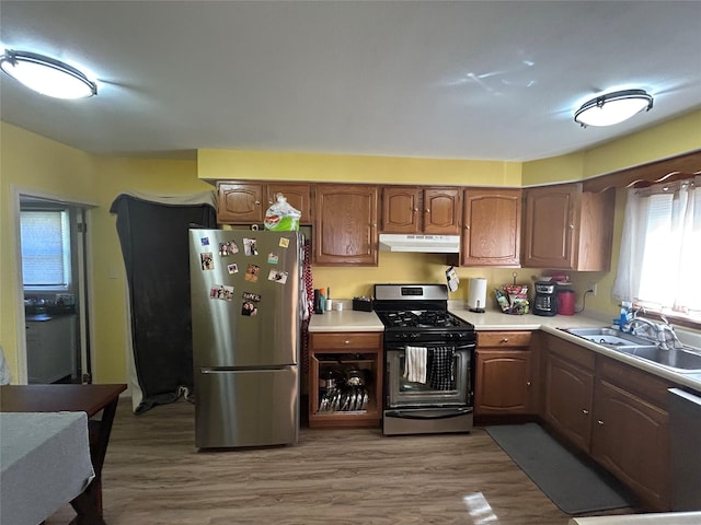 607 E Jasper St, Pleasantville, IA 50225 - kitchen with freestanding refrigerator, gas range, under cabinet range hood, and light countertops