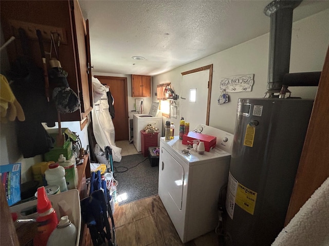 607 E Jasper St, Pleasantville, IA 50225 - laundry area featuring water heater, washer and dryer, a textured ceiling, wood finished floors, and cabinet space