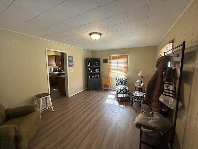 607 E Jasper St, Pleasantville, IA 50225 - sitting room featuring dark wood-style flooring, wooden walls, and ornamental molding