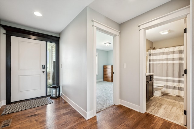629 Mallard Pointe Dr NW, Bondurant, IA 50035 - entryway with dark wood-style floors and recessed lighting