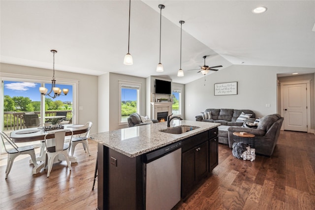 629 Mallard Pointe Dr NW, Bondurant, IA 50035 - kitchen featuring dishwasher, a lit fireplace, vaulted ceiling, dark wood finished floors, and a ceiling fan