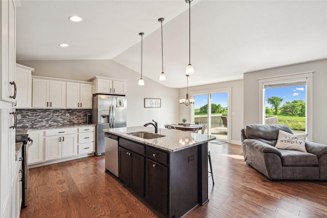 629 Mallard Pointe Dr NW, Bondurant, IA 50035 - kitchen with appliances with stainless steel finishes, open floor plan, white cabinetry, dark brown cabinetry, and vaulted ceiling