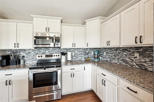 629 Mallard Pointe Dr NW, Bondurant, IA 50035 - kitchen with appliances with stainless steel finishes, white cabinetry, stone countertops, and decorative backsplash