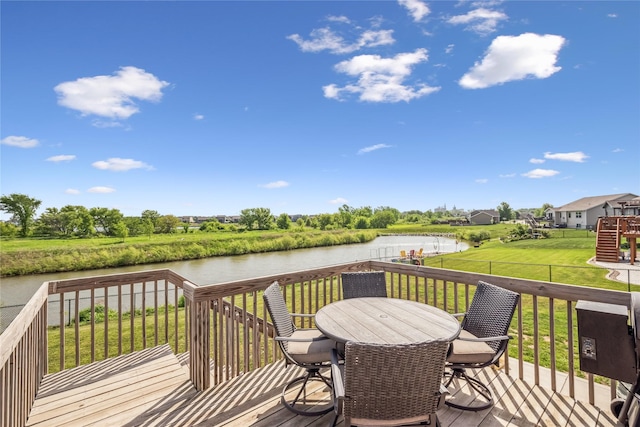 629 Mallard Pointe Dr NW, Bondurant, IA 50035 - wooden terrace featuring a water view, outdoor dining area, and a fenced backyard