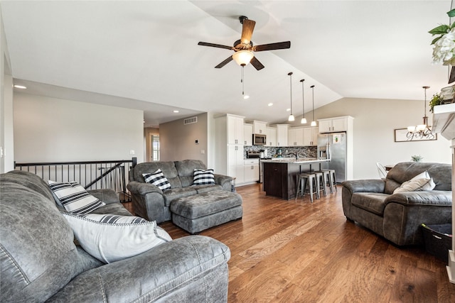 629 Mallard Pointe Dr NW, Bondurant, IA 50035 - living room featuring vaulted ceiling, ceiling fan, a chandelier, wood finished floors, and recessed lighting