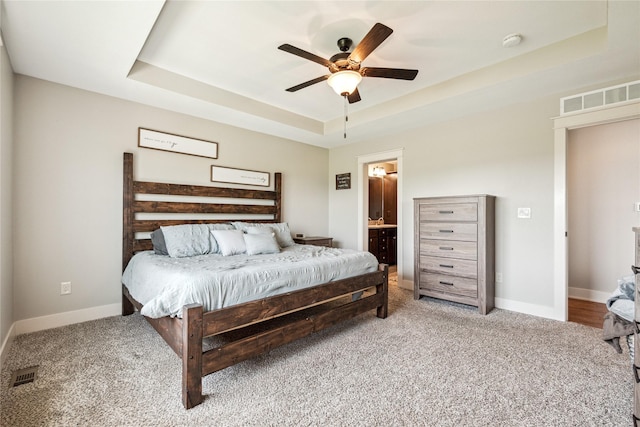 629 Mallard Pointe Dr NW, Bondurant, IA 50035 - bedroom featuring a raised ceiling, carpet flooring, ensuite bath, and a ceiling fan
