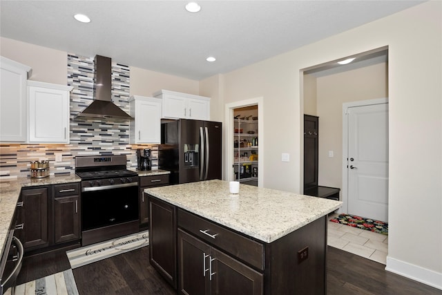 465 NW Gracewood Dr, Waukee, IA 50263 - kitchen featuring black fridge, stainless steel gas stove, range hood, white cabinets, and recessed lighting