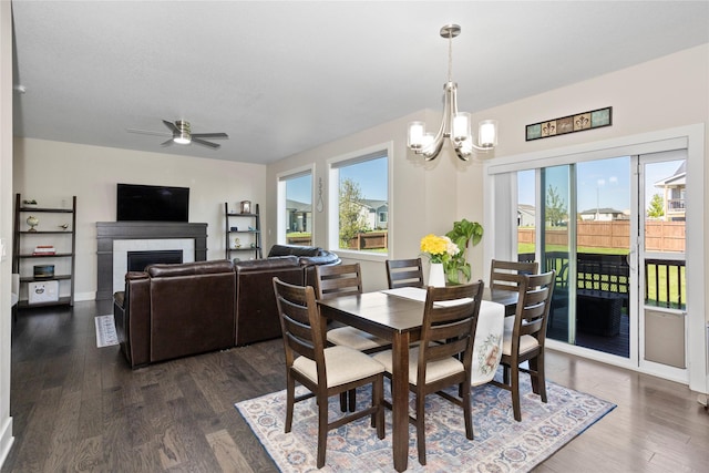 465 NW Gracewood Dr, Waukee, IA 50263 - dining room featuring dark wood-style flooring, a ceiling fan, a chandelier, and a fireplace