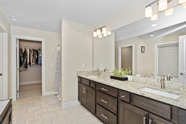 465 NW Gracewood Dr, Waukee, IA 50263 - bathroom featuring double vanity and a walk in closet