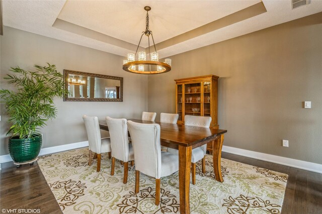 9416 Rushbrook Dr, Johnston, IA 50131 - dining space with wood finished floors, a chandelier, and a raised ceiling