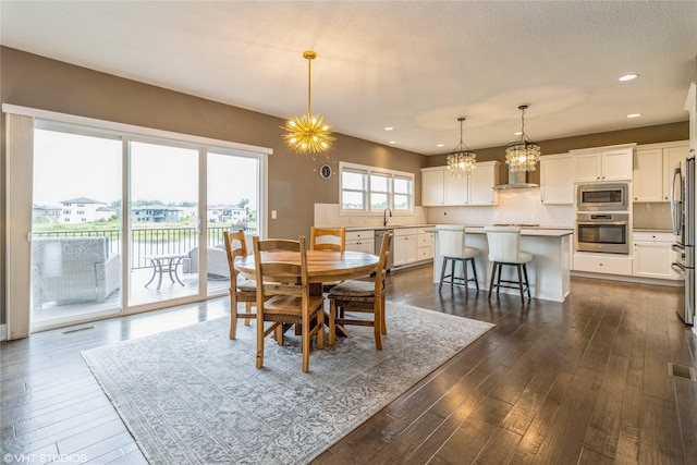 9416 Rushbrook Dr, Johnston, IA 50131 - dining area with a chandelier, recessed lighting, and dark wood finished floors