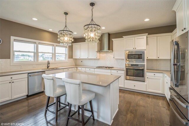 9416 Rushbrook Dr, Johnston, IA 50131 - kitchen with appliances with stainless steel finishes, wall chimney exhaust hood, tasteful backsplash, white cabinets, and recessed lighting