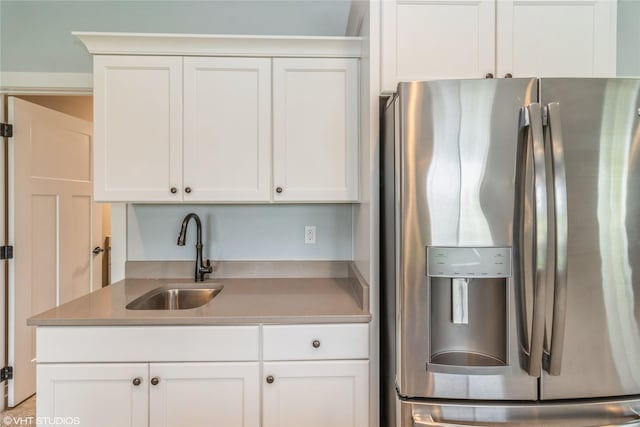 9416 Rushbrook Dr, Johnston, IA 50131 - kitchen featuring stainless steel fridge with ice dispenser, white cabinets, and light countertops