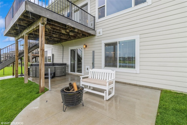 9416 Rushbrook Dr, Johnston, IA 50131 - view of patio / terrace with a hot tub, a fire pit, stairs, and a deck