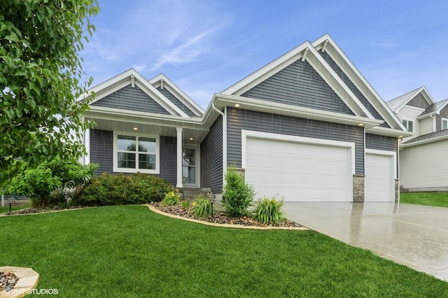 2401 E 50th St, Des Moines, IA 50317 - view of front of home featuring concrete driveway, a garage, and a front yard
