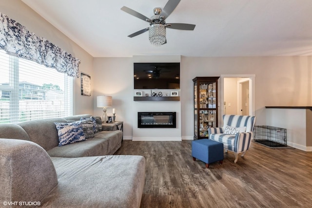2401 E 50th St, Des Moines, IA 50317 - living area featuring wood finished floors, ceiling fan, and a glass covered fireplace