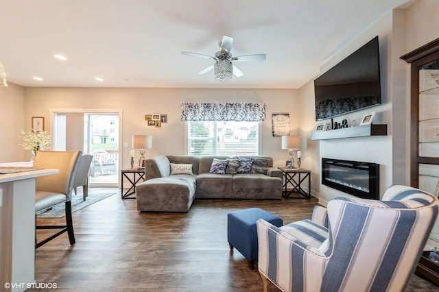 2401 E 50th St, Des Moines, IA 50317 - living area featuring wood finished floors, ceiling fan, a glass covered fireplace, and recessed lighting