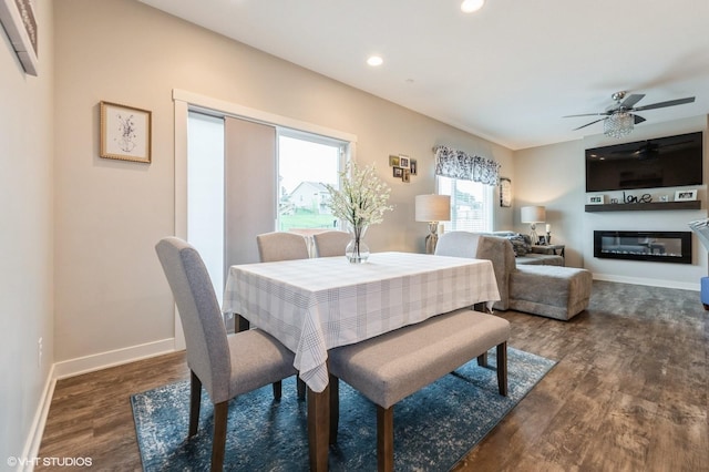 2401 E 50th St, Des Moines, IA 50317 - dining space with wood finished floors, ceiling fan, a glass covered fireplace, and recessed lighting